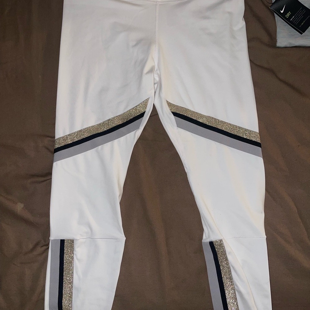 Nike Women's White Track Pants with Black and Gold Accents